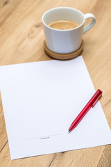 Paper with signature and red pen on desk