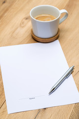 Paper with signature and grey pen on desk