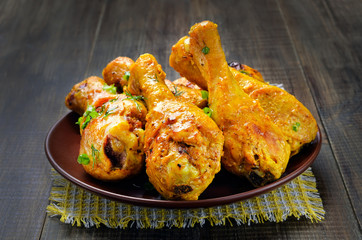 Fried chicken drumsticks on ceramic plate