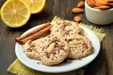 Almond cookies on white plate, close up view