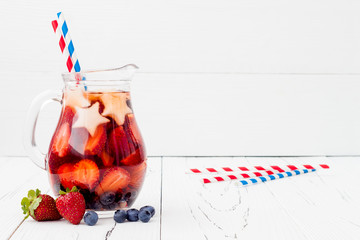 Red, White and Blue Lemonade or Sangria. Patriotic drink cocktail with strawberry, blueberry and...