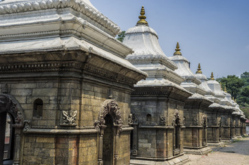 Fototapeta na wymiar Votive temples and shrines in a row at Pashupatinath Temple, Kathmandu, Nepal - Sri Pashupatinath Temple located on the banks of the Bagmati River.