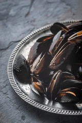 Folds mussels on an old metal plate on a slate