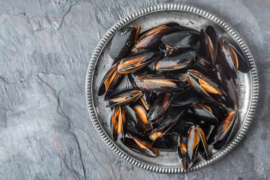 Folds mussels on an old metal plate on a slate