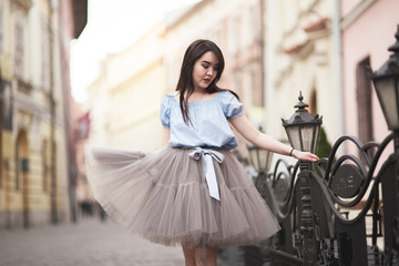 Young Asians girl with modern dress posing in an old Krakow