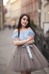 Young Asians girl with modern dress posing in an old Krakow