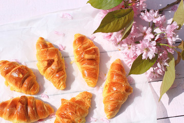Fresh French croissants on old wooden background, romantic breakfast in the garden - 111094531