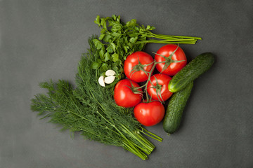 Top view of fresh vegetables and spices on dark wooden background. Vegetarian food, health or cooking concept.
