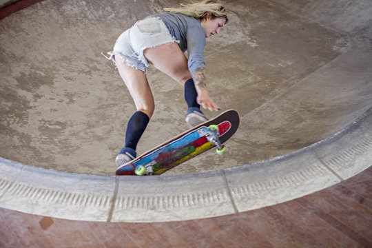 Young woman skateboarding.