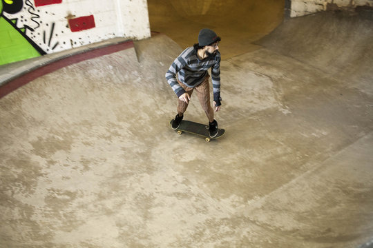 Young man skateboarding at basement skate park