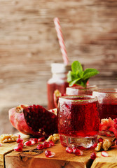 Fresh pomegranates and juice, selective focus