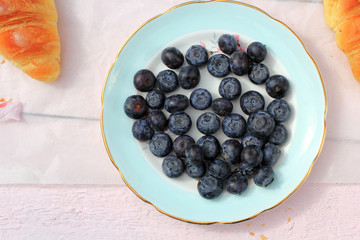 A small saucer with blackberries for morning breakfast, close up 