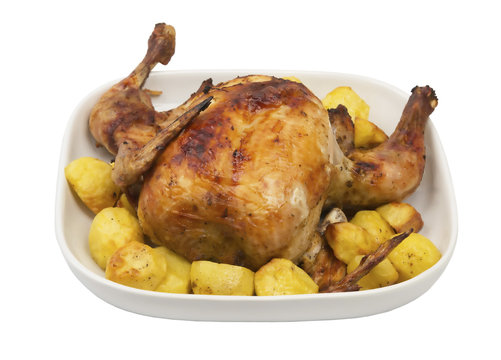 roasted chicken on a plate with potatoes