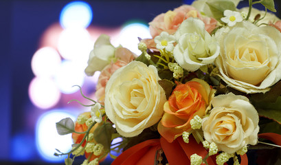 Artificial rose flowers on light blurred bokeh background.