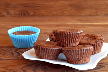 Homemade sweet pastry. Homemade tasty cupcakes on a table. Sweet muffins are made of eggs, butter, chocolate, cocoa, sugar, flour