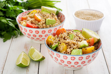 Quinoa salad in bowl on white wooden table
