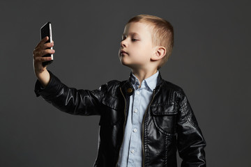 little boy selfie. funny child with a phone. little photographer