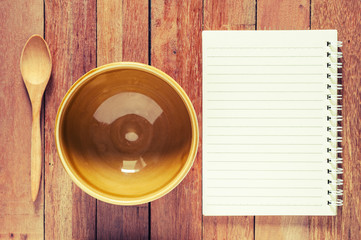 Brown bowl with spoon and notebook