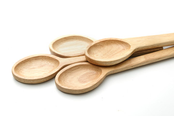 Four wooden spoons isolated on white.