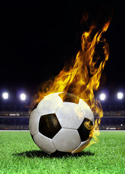 fiery soccer ball on stadium