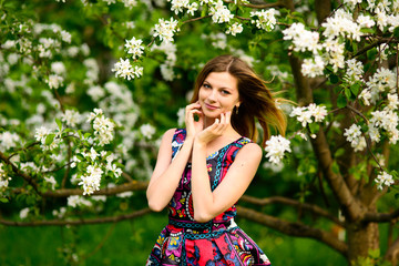 Beautiful woman in blooming garden