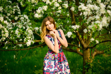 Beautiful woman in blooming garden