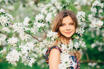 Beautiful woman in blooming garden