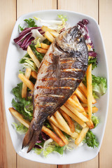 Grilled fish with salad and french fries