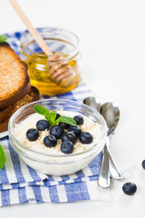 Yogurt with fresh blueberries, honey and toast, healthy breakfast