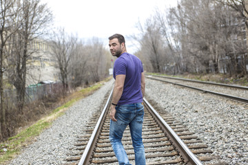 nice young man portrait on the railroad