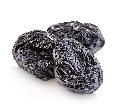 Raw organic prunes, dried plums, smoked prunes close-up on a white background.