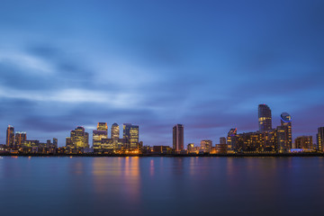 Fototapeta na wymiar London, UK - The famous business district and skyscrapers of Canary Wharf at blue hour