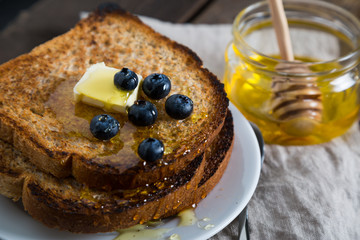 Fried toast with honey and fresh blueberries