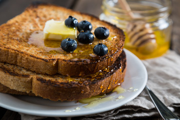Fried toast with honey and fresh blueberries