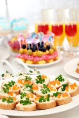 Set of cold snacks, canape, beverages, closeup