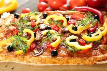 Rectangle delicious pizza and vegetables on the table, close-up