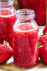 Strawberry smoothie in glass bottles, fresh berries, vintage woo