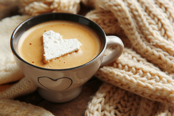 Cup of coffee with marshmallow on wooden table