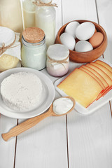 Set of fresh dairy products on white wooden table
