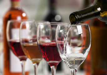 White wine pouring into glasses, closeup