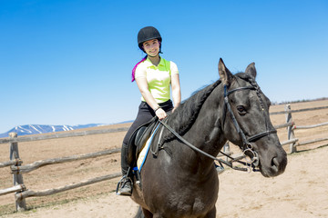 Beautiful teen girl on the farm with her horse.