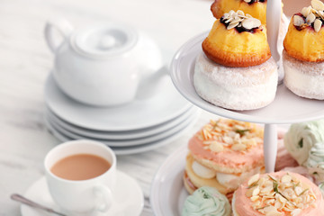 Cake stand with different sweets and tea