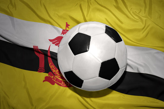 black and white football ball on the national flag of brunei