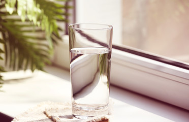 Glass of pure water on windowsill