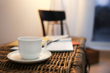 Cup of tea on wicker table, closeup