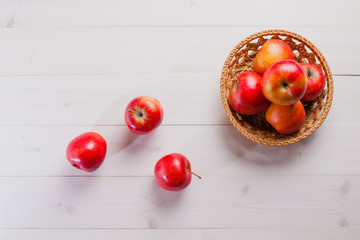 few apples on a white background with the basket