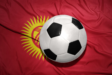 black and white football ball on the national flag of kyrgyzstan