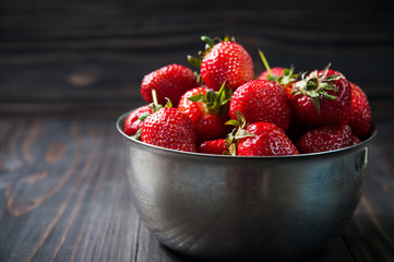 Fresh strawberries on old wooden background