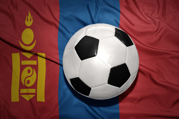 Fototapeta premium black and white football ball on the national flag of mongolia