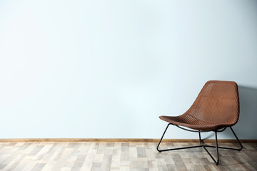 Comfortable chair on blue wall background